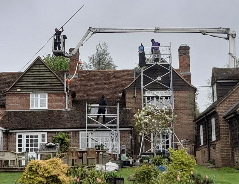 The Roof Moss Cleaners using cherry picker and scaffolding to clean roof safely and professionally in Wheatley, Oxfordshire